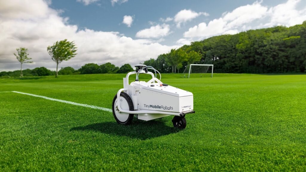 GPS-guided robotic field marking system painting an athletic field line