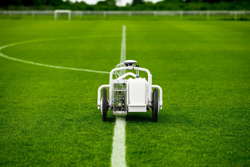 Robotic field marking system repainting a soccer field line with GPS-guided precision